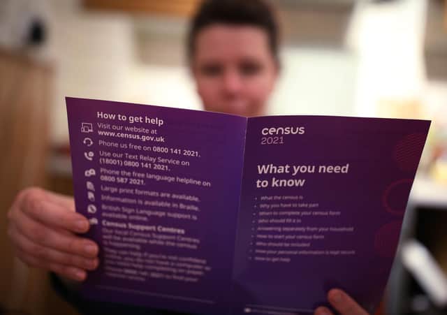 A woman reading a leaflet from the Office for National Statistics (ONS) containing information about The Census 2021, sent to households in England and Wales. Picture date: Monday March 22, 2021.