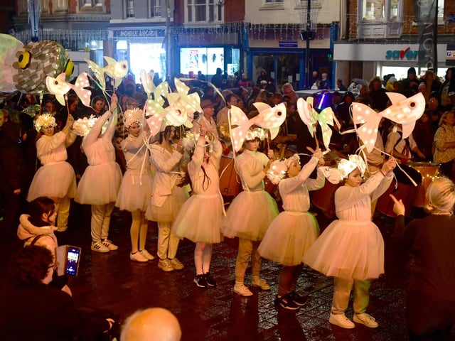 Children with fish-shaped lanterns dressed up for the Illuminate Parade.