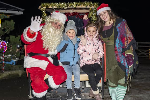 Henry Panton, 6 and Amy Simons, 7 with Santa and his elf. Photos: Holly Parkinson Photography