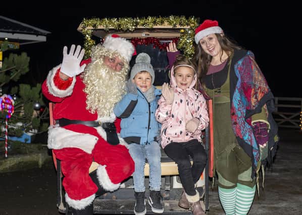 Henry Panton, 6 and Amy Simons, 7 with Santa and his elf. Photos: Holly Parkinson Photography
