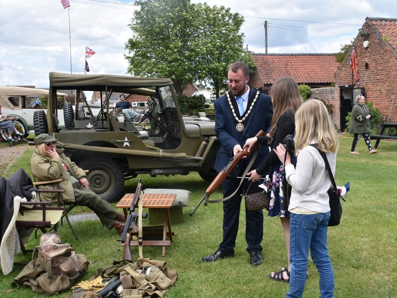 Skegness Mayor, Coun Dan Kirk, gets hands-on with some of the vintage weaponry at the event.