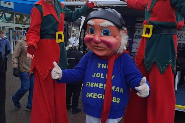 The Jolly Fisherman with stilt walkers at Skegness Christmas Market.