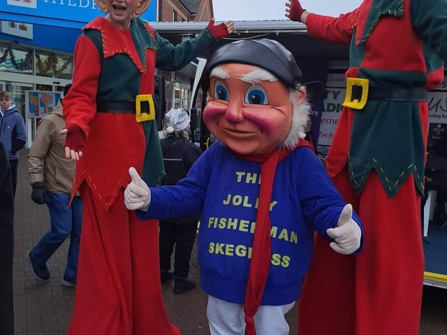 The Jolly Fisherman with stilt walkers at Skegness Christmas Market.