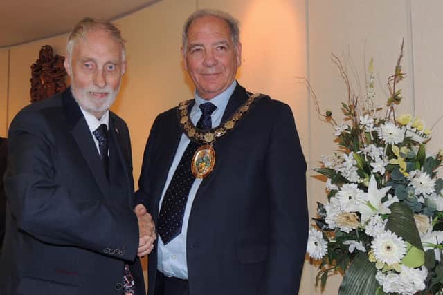 Coun Mike Clarke passes on the chain of office to Coun Andrew Hagues.