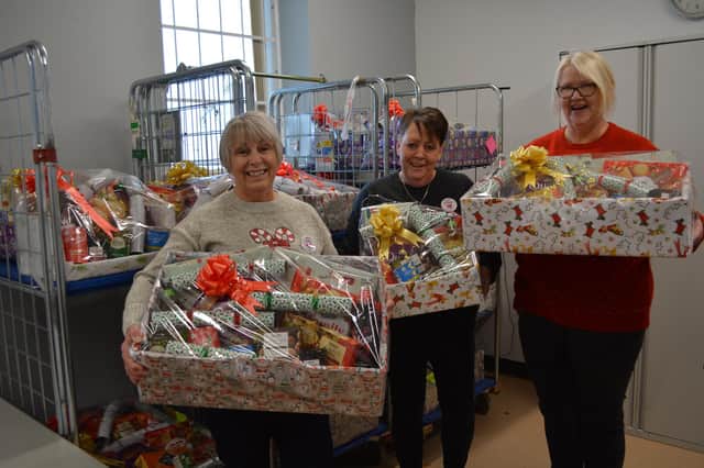 Judy Parker, left, Rachael Bell and Amanda Nelson with some of the 37 hampers