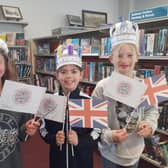 Eleanor, Izzy and Edith with their crowns and flags.