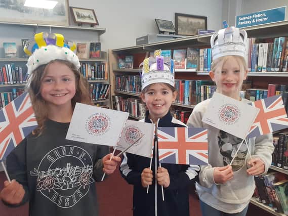 Eleanor, Izzy and Edith with their crowns and flags.