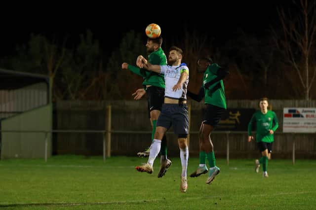 Tom Ward goes up for a header against Sherwood. Photo: Steve W Davies Photography.