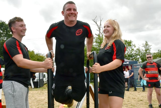 L-R Cian McLarnon, Dan Mackie, Charlotte Hancock of Sleaford Rugby Club doing the dip challenge.