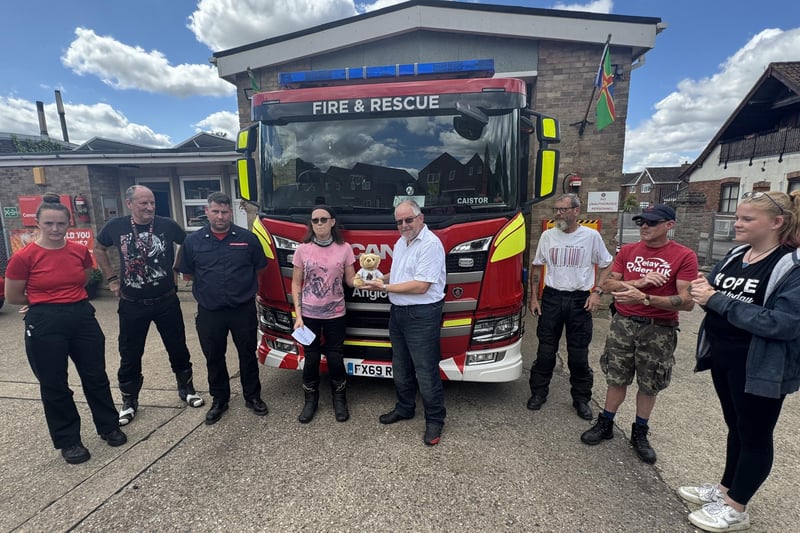 Firefighters at Caistor welcome Michelle Gardner and Kibi Bear on the relay.