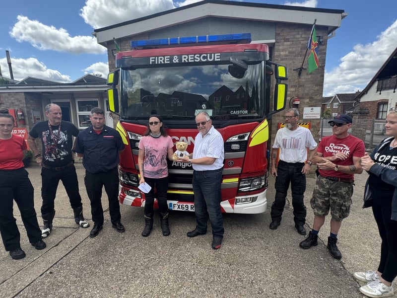 Firefighters at Caistor welcome Michelle Gardner and Kibi Bear on the relay.