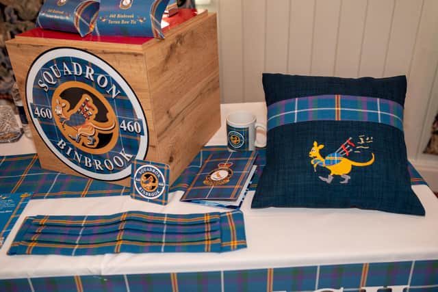 The colours represent the unity of the Commonwealth - purple for Scotland, red for Wales, green for Ireland, white for England and yellow for Australia, with blue
representing the history of the RAF and the RAAF,