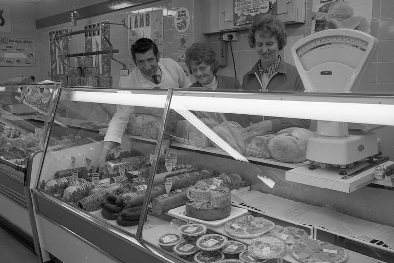 Posing for the Standard photographer, meat manager Frank Beeson, Jessie Barwick and Mavis Harvey.