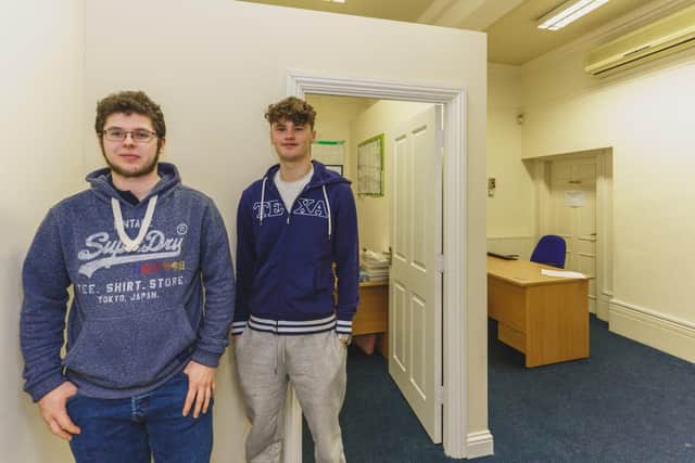 Apprentices Kenny and Drew in front of the new office