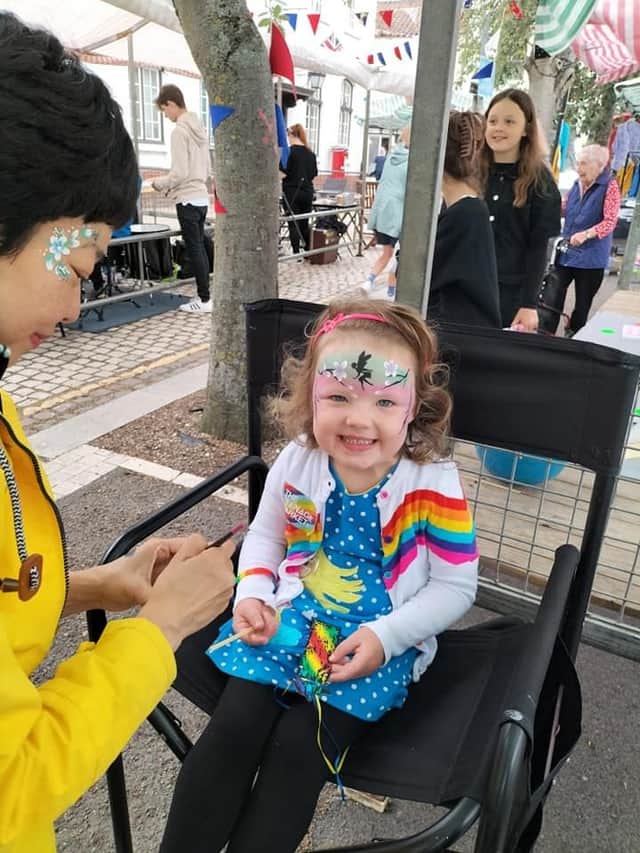 Facepainting at the Teenage Market.