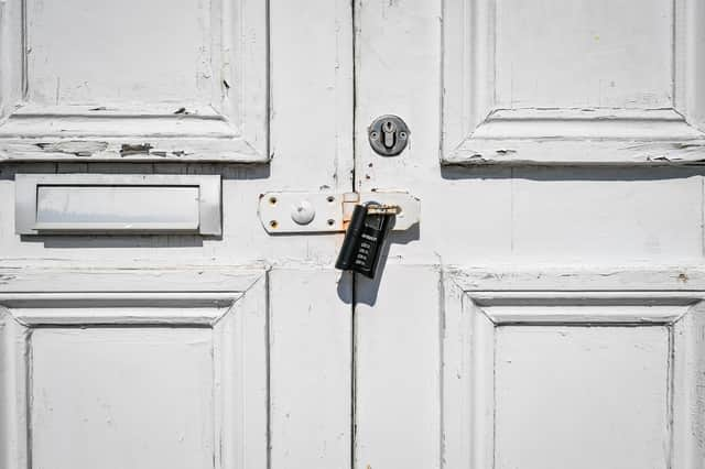 NOTE: IMAGE 12 OF A SET OF 35 IMAGES FEATURING LOCKED GATES OF BUSINESSES AND PLACES THAT ARE CLOSED DURING UK LOCKDOWN A black combination lock secures a hasp on a door to a puzzlair escape game centre in Bristol to prevent access as the UK continues in lockdown to help curb the spread of the coronavirus.