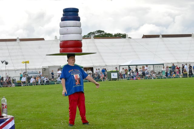 John Evans: Strongman, performs for the crowd in the main arena.