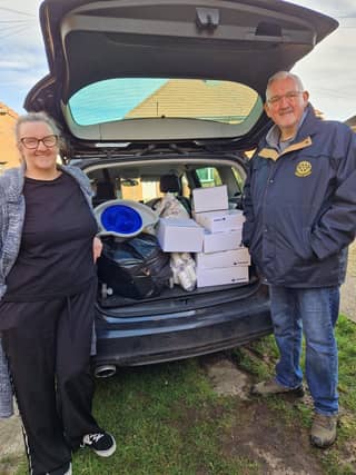 Rotarian Malcolm and daughter deliver goods for transport on to Ukraine