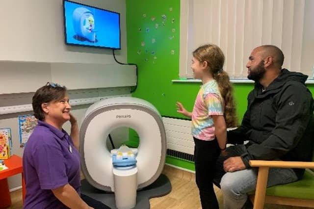 Sandy Crook, Phoebe McCormack and dad Chris with the Kitten Scanner.