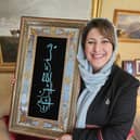 Hassina Syed with a gift from Afghanistan's Minister of Mines and Petroleum Maulvi Shahabuddin Delawar - which translates to 'In the name of God, the merciful and compassionate'.