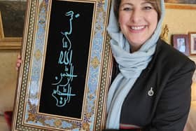 Hassina Syed with a gift from Afghanistan's Minister of Mines and Petroleum Maulvi Shahabuddin Delawar - which translates to 'In the name of God, the merciful and compassionate'.