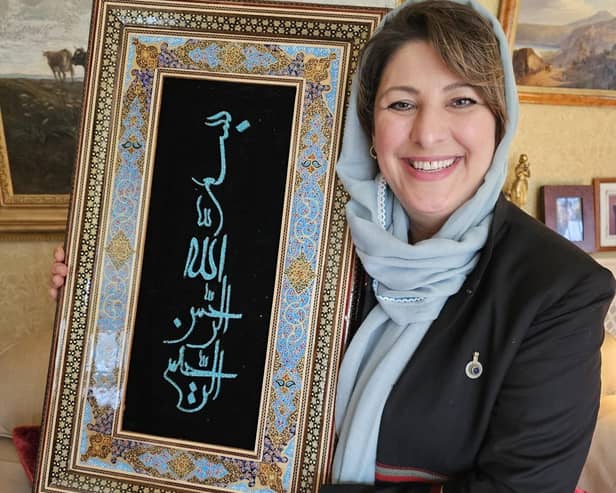 Hassina Syed with a gift from Afghanistan's Minister of Mines and Petroleum Maulvi Shahabuddin Delawar - which translates to 'In the name of God, the merciful and compassionate'.