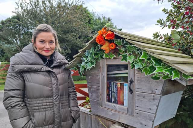 Tracey Gartshore with the book box cleaned and fully stocked after the vandalism.