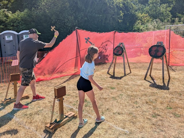 Ben Sharpe and Luna Sharpe, 9, of Hundleby, have a go at axe-throwing.
