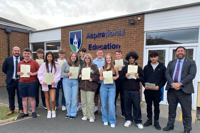 ​Mr Dickinson (right) and Mr Hermiston with successful GCSE students after receiving their results.