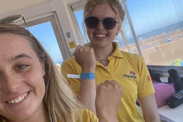 Lifeguards show the Sandi Starfish wristbands that can help then reunite children with their parents.