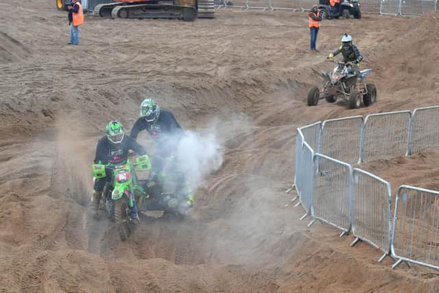 Smoking! Action hots up at the quad bikes and side car racing.