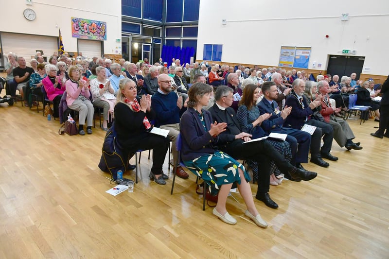 A full house. The audience applaud the concert band.