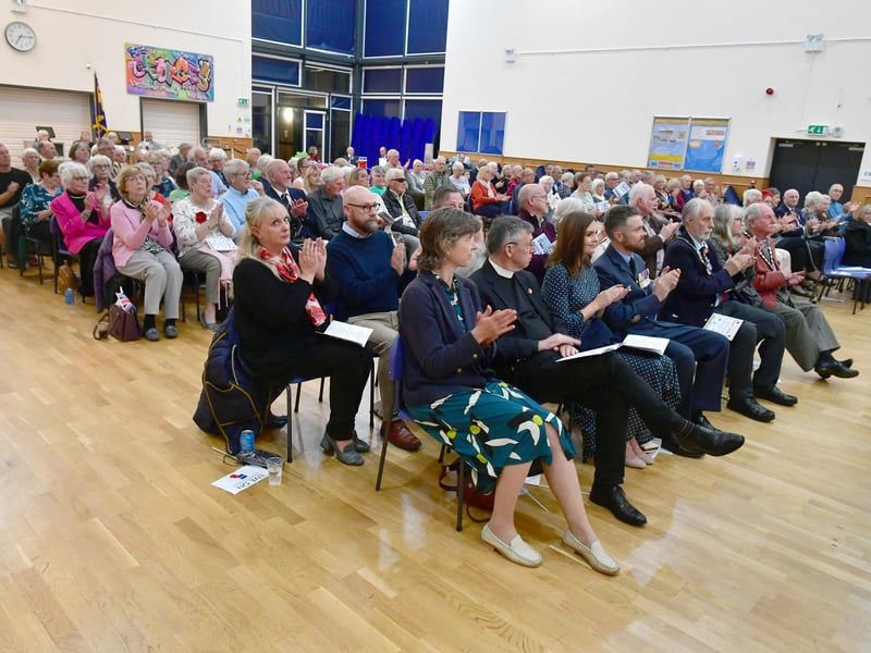 A full house. The audience applaud the concert band.