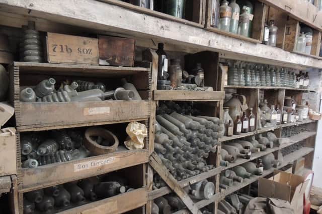 The amazing wall of old medicine bottles in the old upstairs store room.