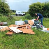A council officer inspecting a fly-tipping site in West Lindsey.