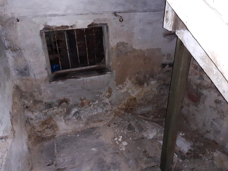 This remarkable find began life as 'a cupboard with a draft', Shane said. Once Shane had removed the cupboard, he found stone steps leading down to a small room with a flagstone floor and a barred window (which looks towards the tunnel). Other features include hooks and an oddly decorative area above the doorway. Given the age of the flooring, Shane wonders if the space somehow relates to the Dominican friary that once stood in the area (the remains of which became Blackfriars Theatre and Arts Centre).