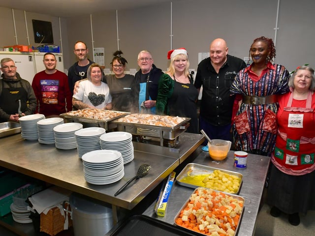 Volunteers in the kitchen at the Storehouse who prepared the meal with hostess Bamidele Akomolafe l.