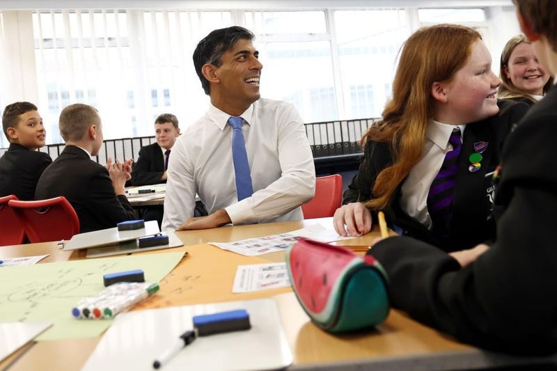 The PM reacts as he sits with pupils in a science lesson. (Photo by Darren Staples - WPA Pool/Getty Images)