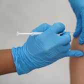File photo dated 31/07/21 of a person receiving a Covid-19 jab, as Scottish Government ministers have been asked if there are any barriers preventing people from buying a Covid booster shot at their local pharmacy as the virus enters its third winter.