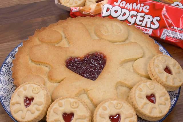 The giant Jammie Dodger - and how it sizes up to the shop-bought biscuit. Picture: B&M.
