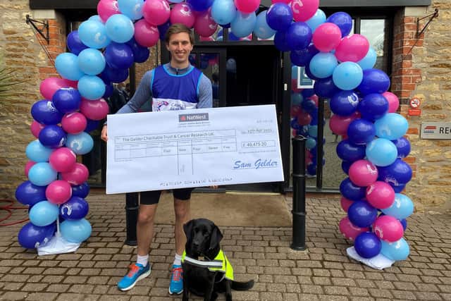 Sam with his dog Tasha and the £49,475.20 cheque