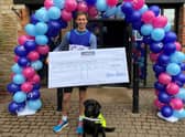 Sam with his dog Tasha and the £49,475.20 cheque