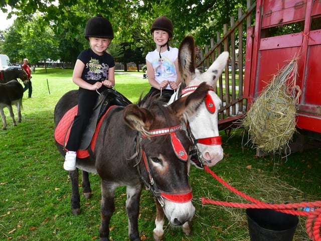 Nikola Drapala, six, and Oliwia Drapala, nine, of Boston, enjoy a donkey ride at Central Park.
