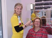 Sophie Hare applying the nasal wax to customer Andrea Kirk.