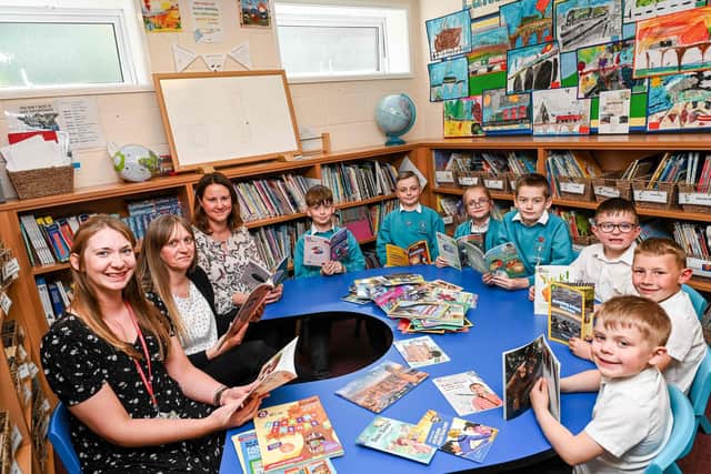 Theddlethorpe Academy School Council members choose new books for the school library. With them are (l-r) Emily Marrows (Reception Teacher), Emma Robinson (English Lead) and Sarah Parkinson, Primary Sales Consultant for Harper Collins.