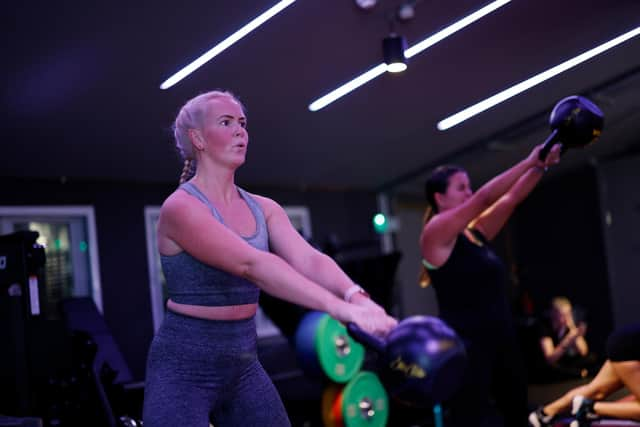 Participants take part in a workout session, which combines strength, resistance, free weight, and bag training. (Photo by John Phillips/Getty Images)