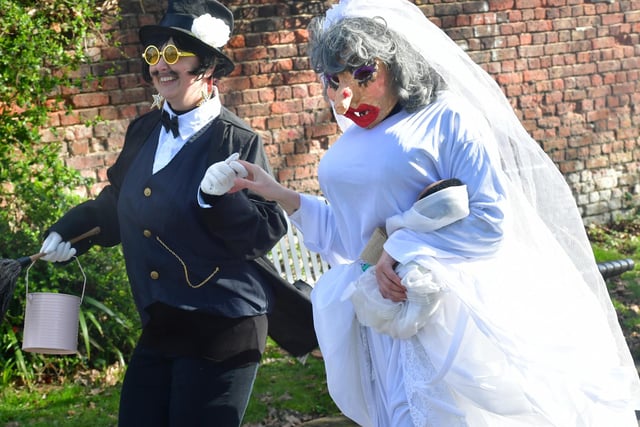 Two costumed characters in the procession.