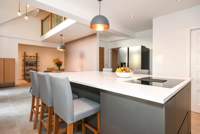 The family breakfast kitchen has fitted appliances and a dining space.
