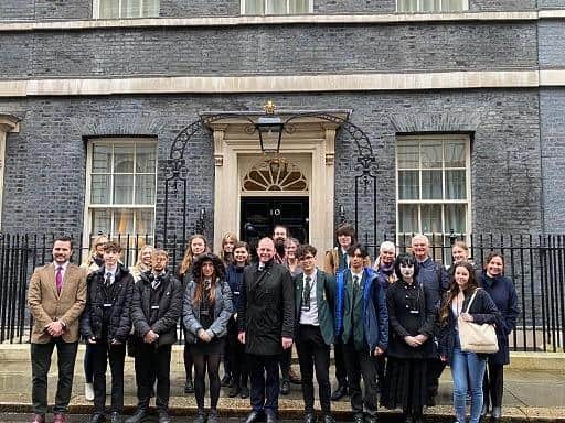 Sudents stood outside 10 Downing Street in London.