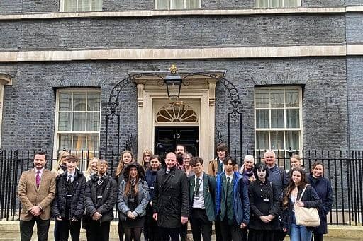 Sudents stood outside 10 Downing Street in London.